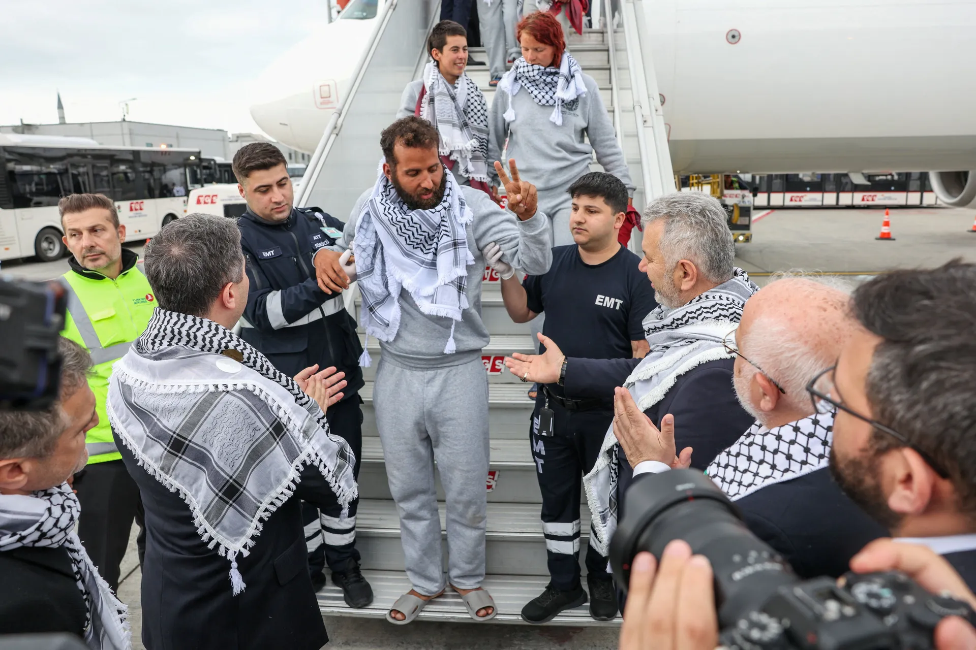 An activist from the Gaza-bound Global Sumud Flotilla, detained by Israeli forces after their vessels were intercepted in international waters in the Mediterranean, receives assistance as he disembarks a plane upon arrival at Istanbul Airport, Turkey, May