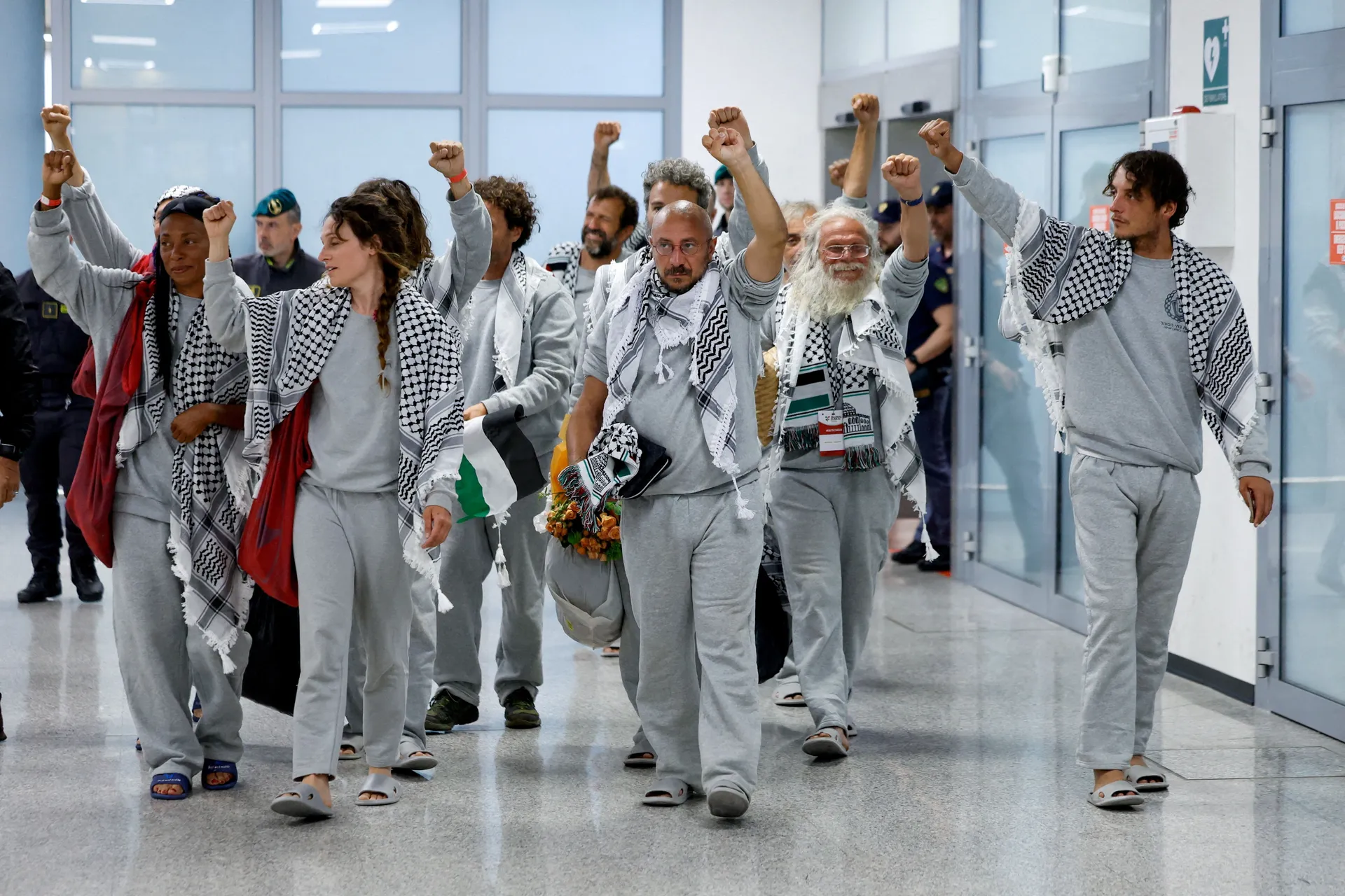 Italian activists from the Gaza-bound Global Sumud Flotilla, detained by Israeli forces after their vessels were intercepted in international waters in the Mediterranean, gesture upon arrival at Fiumicino Airport, in Fiumicino, Italy, May 21, 2026. REUTER