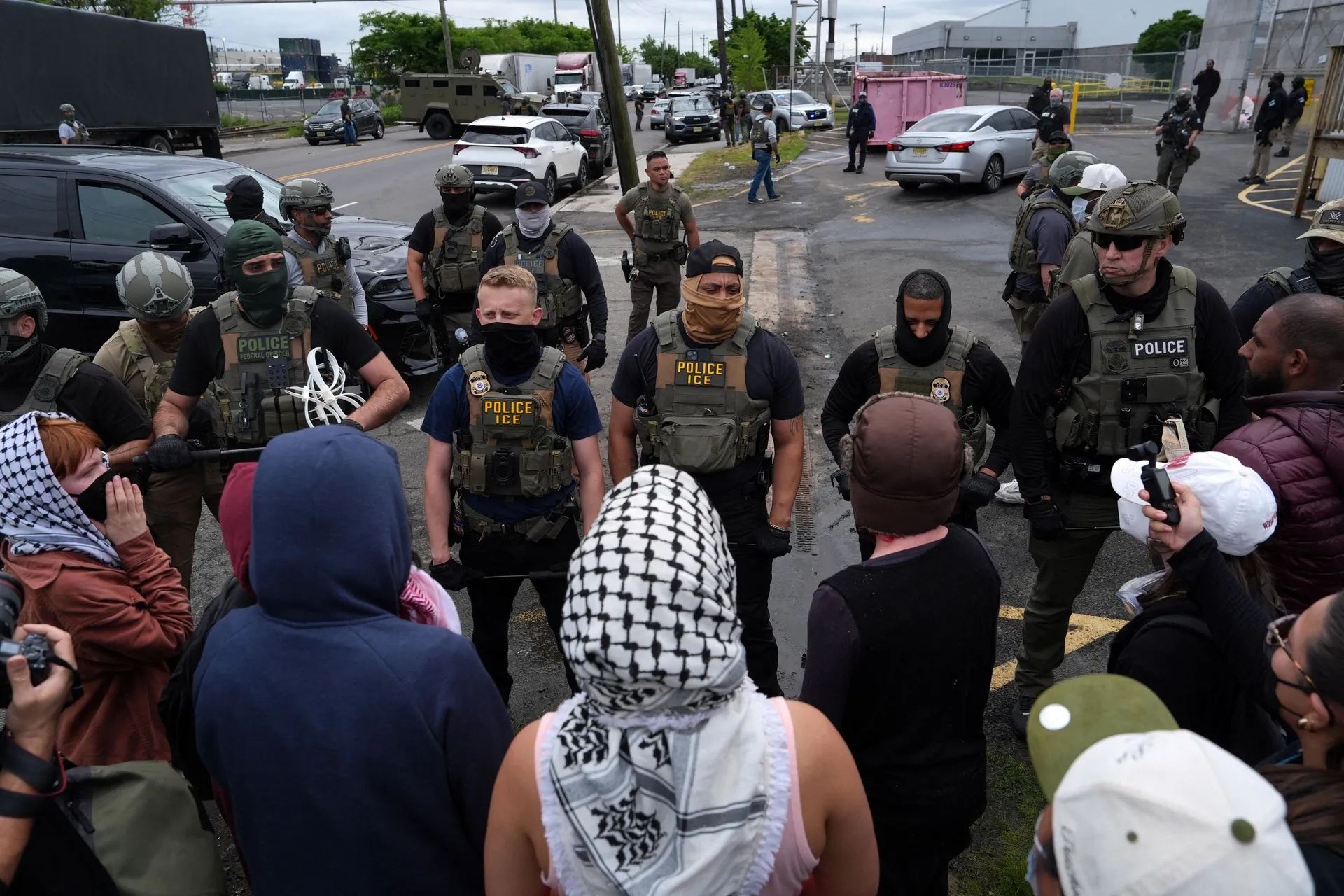 Protesters demonstrate in front of ICE officers outside Delaney Hall in Newark, New Jersey, U.S., May 25, 2026. REUTERS/Ryan Murphy