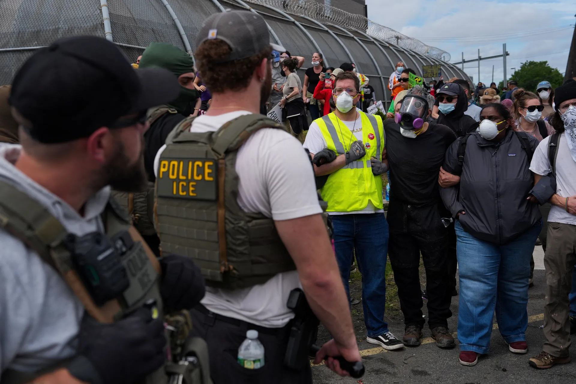 Protesters demonstrate in front of ICE officers outside Delaney Hall in Newark, New Jersey, U.S., May 25, 2026. REUTERS/Ryan Murphy