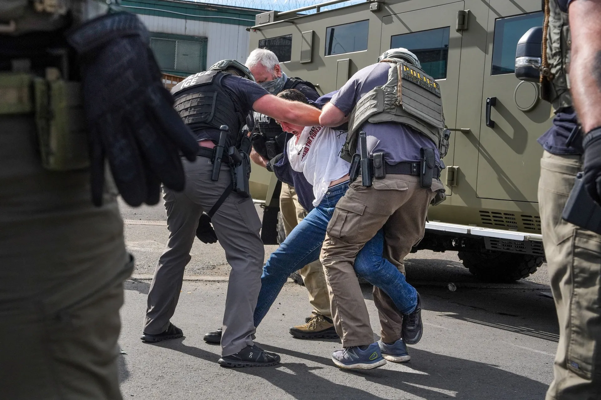 Law enforcement officers detain a demonstrator outside Delaney Hall in Newark, New Jersey, U.S., May 25, 2026. REUTERS/Ryan Murphy