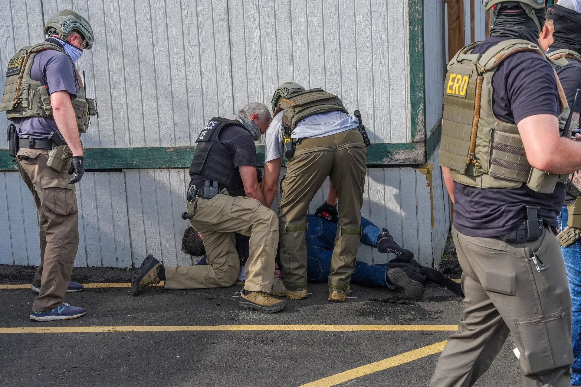 Law enforcement officers detain a demonstrator outside Delaney Hall in Newark, New Jersey, U.S., May 25, 2026. REUTERS/Ryan Murphy