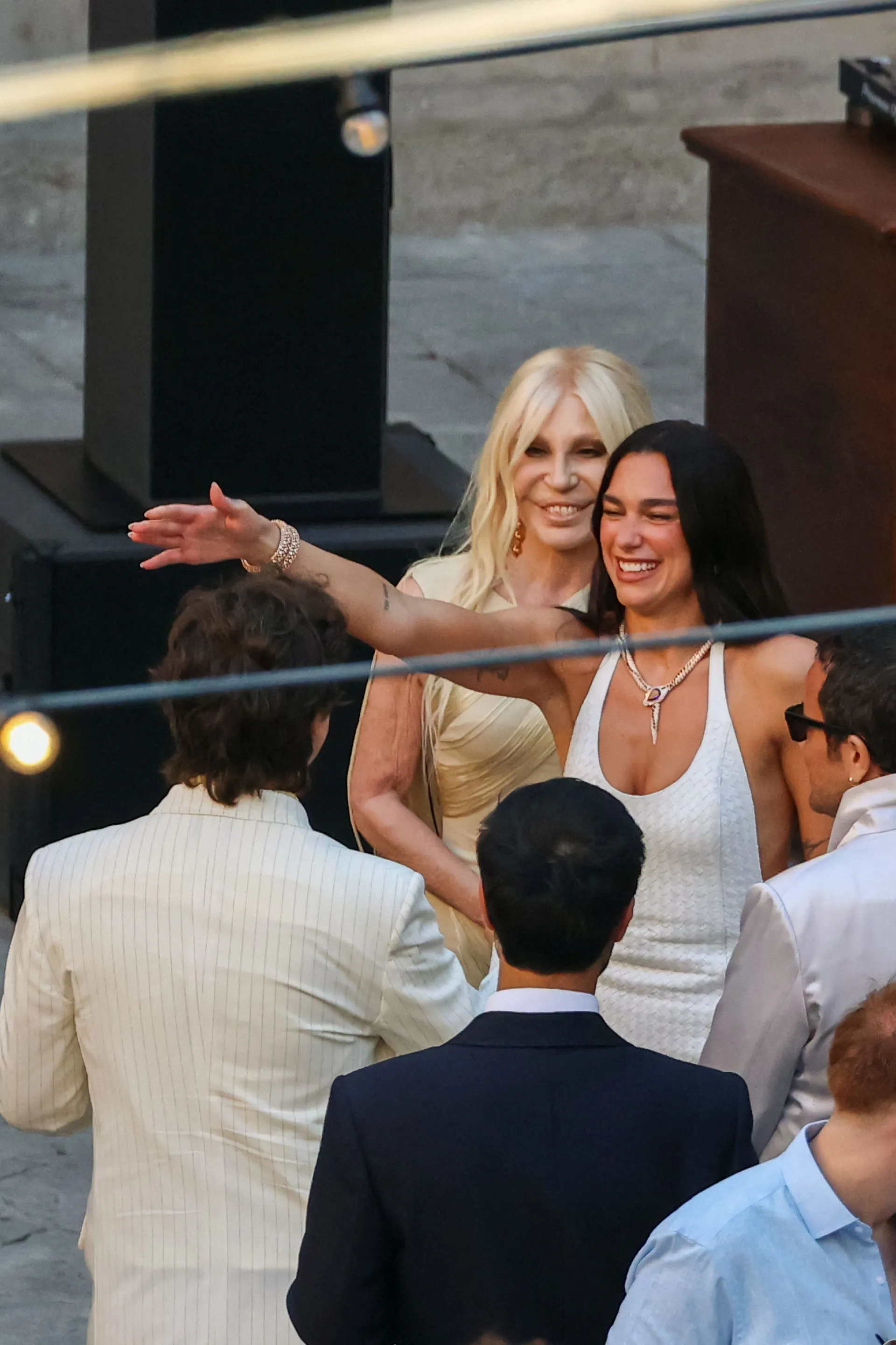 Singer Dua Lipa greets a guest next to designer Donatella Versace during wedding festivities following Lipa’s marriage to actor Callum Turner, in Palermo, Italy, June 5, 2026. REUTERS/Igor Petyx