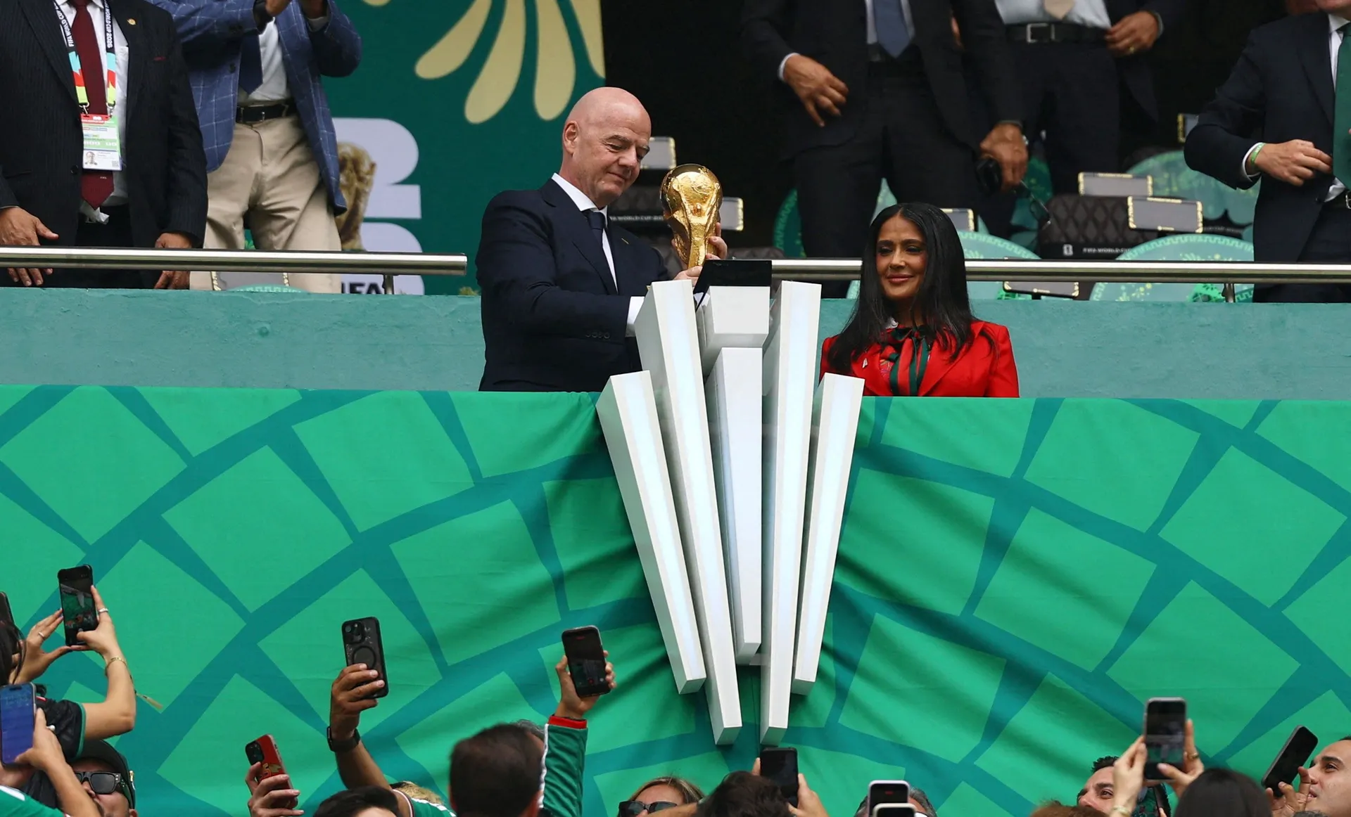 Soccer Football - FIFA World Cup 2026 - Group A - Mexico v South Africa - Estadio Azteca, Mexico City, Mexico - June 11, 2026 FIFA President Gianni Infantino holds the FIFA World Cup trophy alongside actress and FIFA World Cup 2026 Ambassador Salma Hayek 