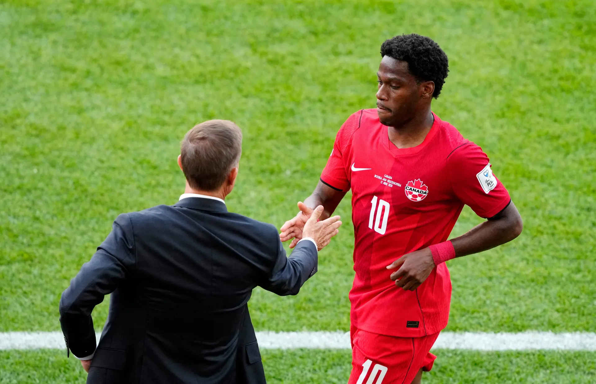 Soccer Football - FIFA World Cup 2026 - Group B - Canada v Bosnia and Herzegovina - Toronto Stadium, Toronto, Canada - June 12, 2026 Canada's Jonathan David with coach Jesse Marsch after being substituted IMAGN IMAGES via Reuters/Kevin Sousa