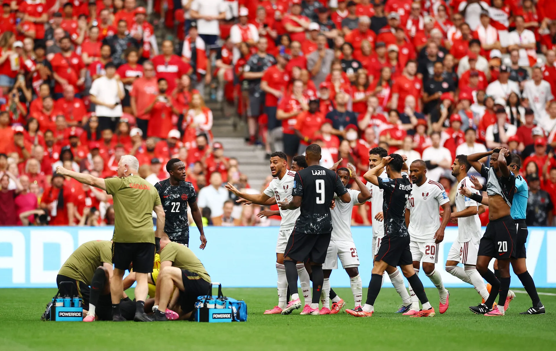 Soccer Football - FIFA World Cup 2026 - Group B - Canada v Qatar - BC Place, Vancouver, Canada - June 18, 2026 Qatar's Mohamed Manai, Assim Madibo and teammates react as Canada's Ismael Kone receives medical attention after sustaining an injury REUTERS/Ag