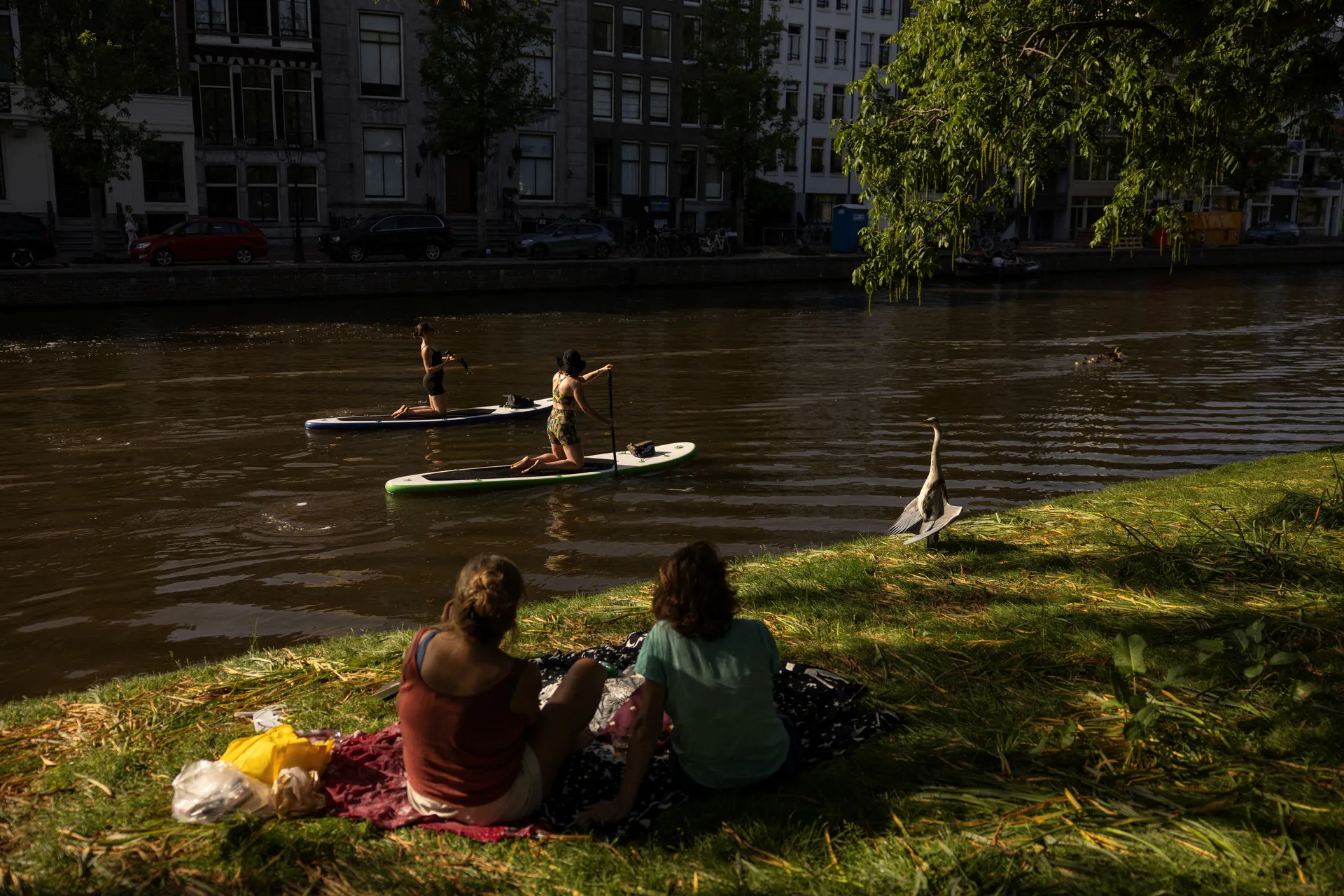 People paddle as others enjoy an unseasonably hot day, in Amsterdam, Netherlands, May 26, 2026. REUTERS/Stelios Misinas