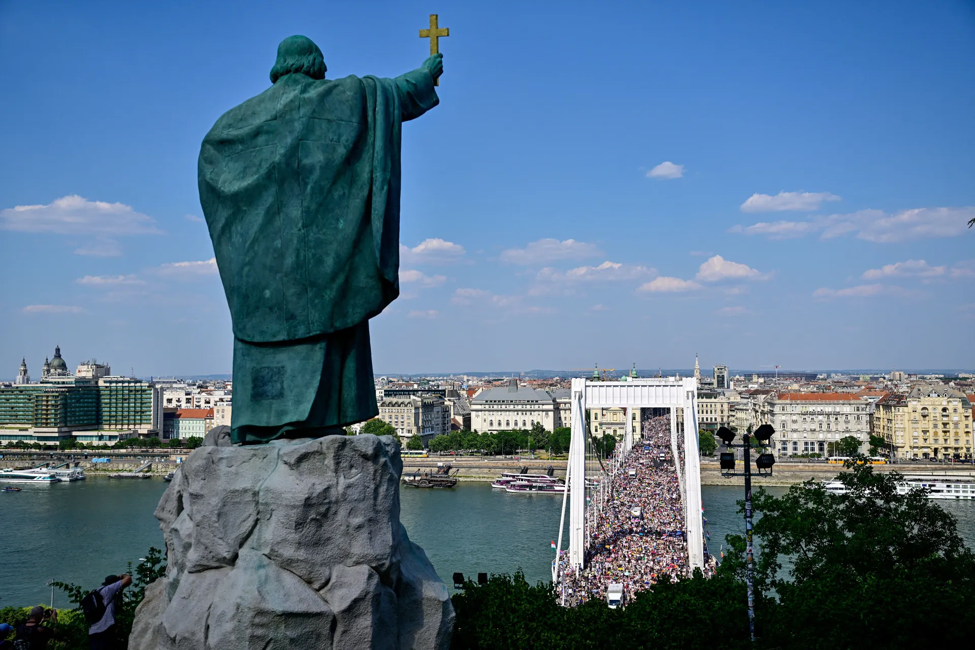 The statue of St. Gellert overlooks the city, as people attend the Budapest Pride March in Budapest, Hungary, June 27, 2026. REUTERS/Marton Monus TPX IMAGES OF THE DAY