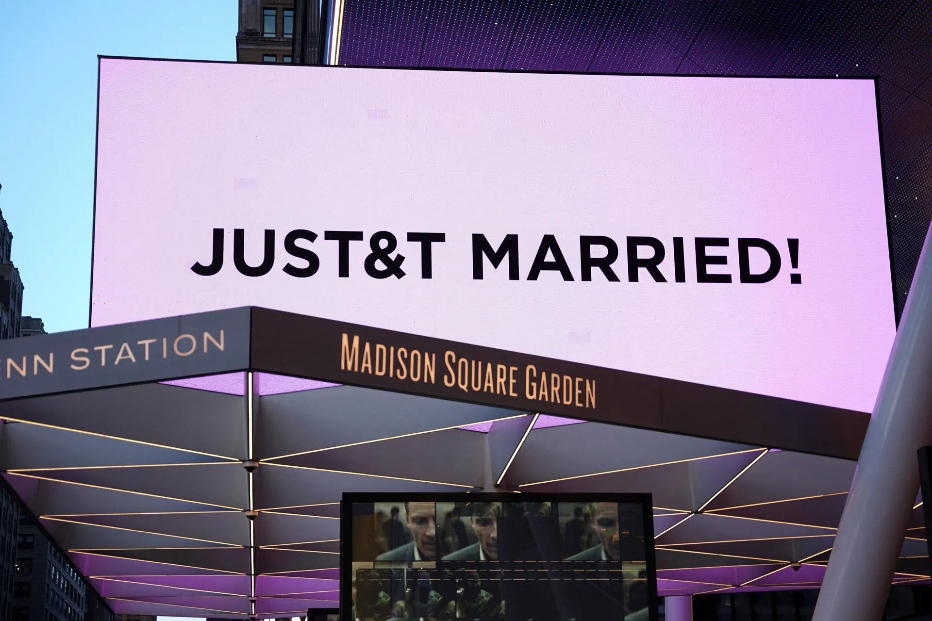 A screen displays a message referencing singer Taylor Swift and National Football League (NFL) player Travis Kelce outside Madison Square Garden, the venue for their reported wedding celebrations, in New York, U.S., July 3, 2026.  REUTERS/Angelina Katsani