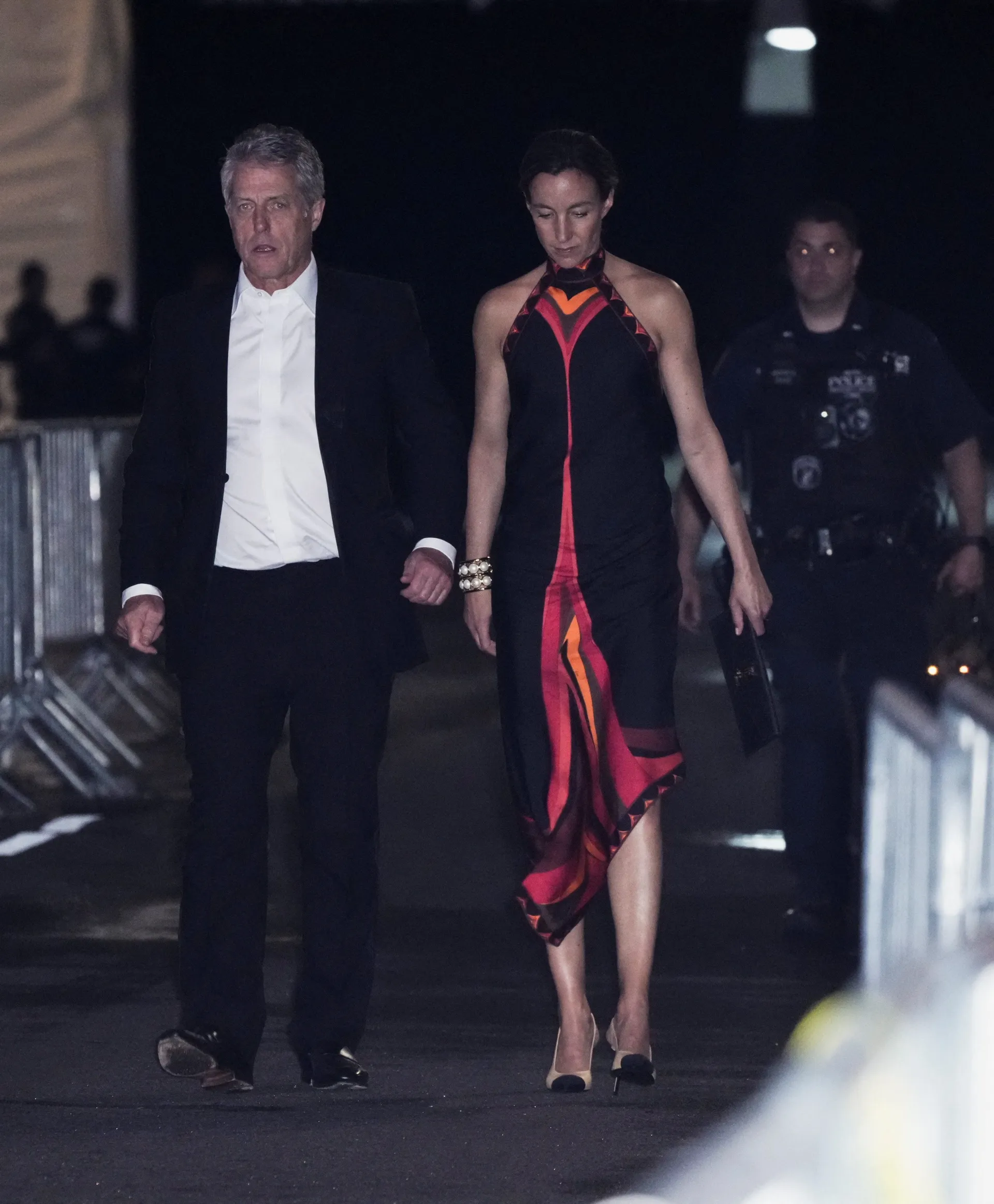 Hugh Grant and his wife, Anna Elisabet Eberstein, depart Madison Square Garden, the venue for the wedding celebrations of singer Taylor Swift and National Football League (NFL) player Travis Kelce, in New York, U.S., July 3, 2026.  REUTERS/Bing Guan
