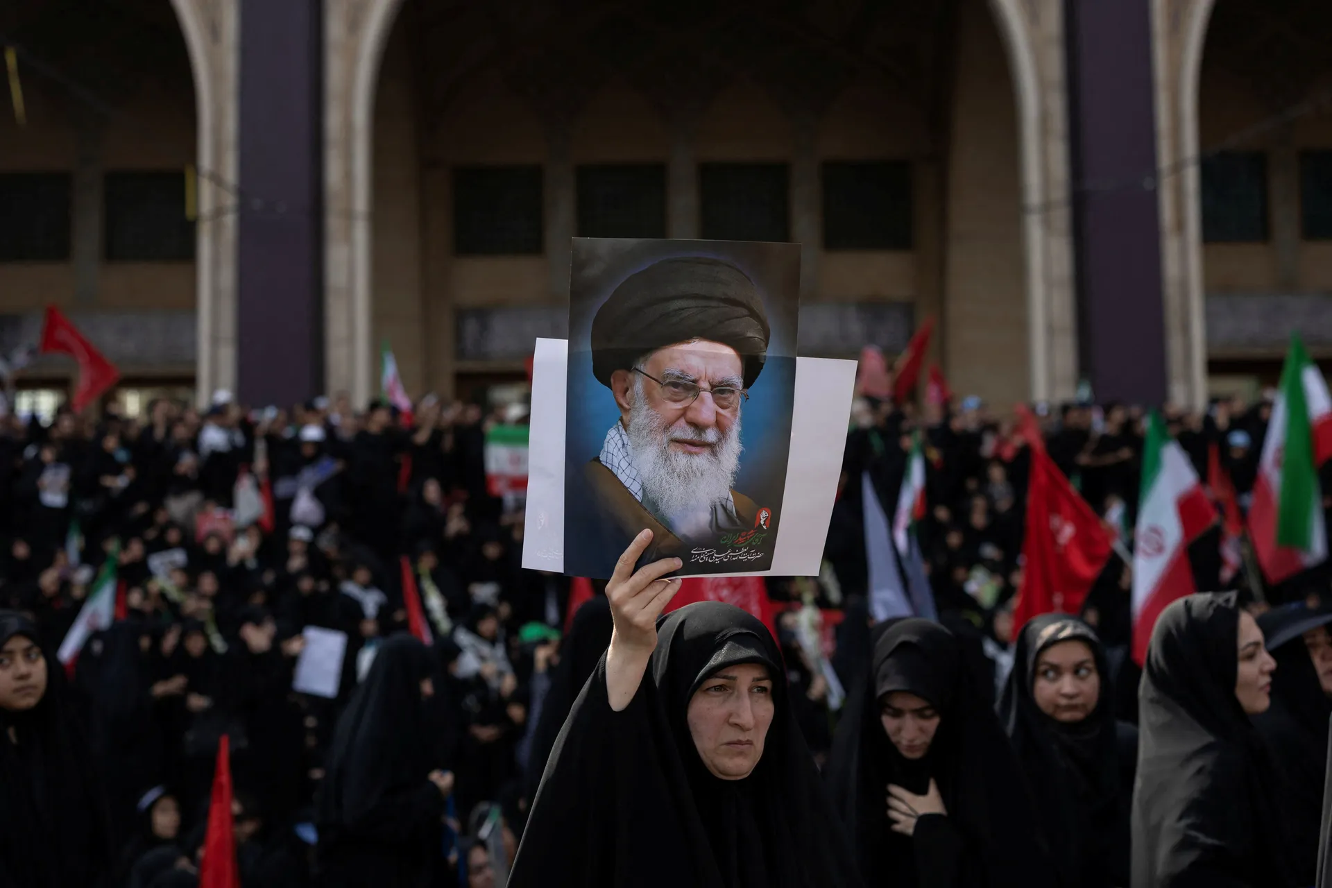A mourner holds a portrait of late Supreme Leader Ayatollah Ali Khamenei, who was killed on February 28 in Israeli and U.S. airstrikes, during a farewell ceremony at the Imam Khomeini Grand Mosalla, in Tehran, Iran July 4, 2026. REUTERS/Alkis Konstantinid