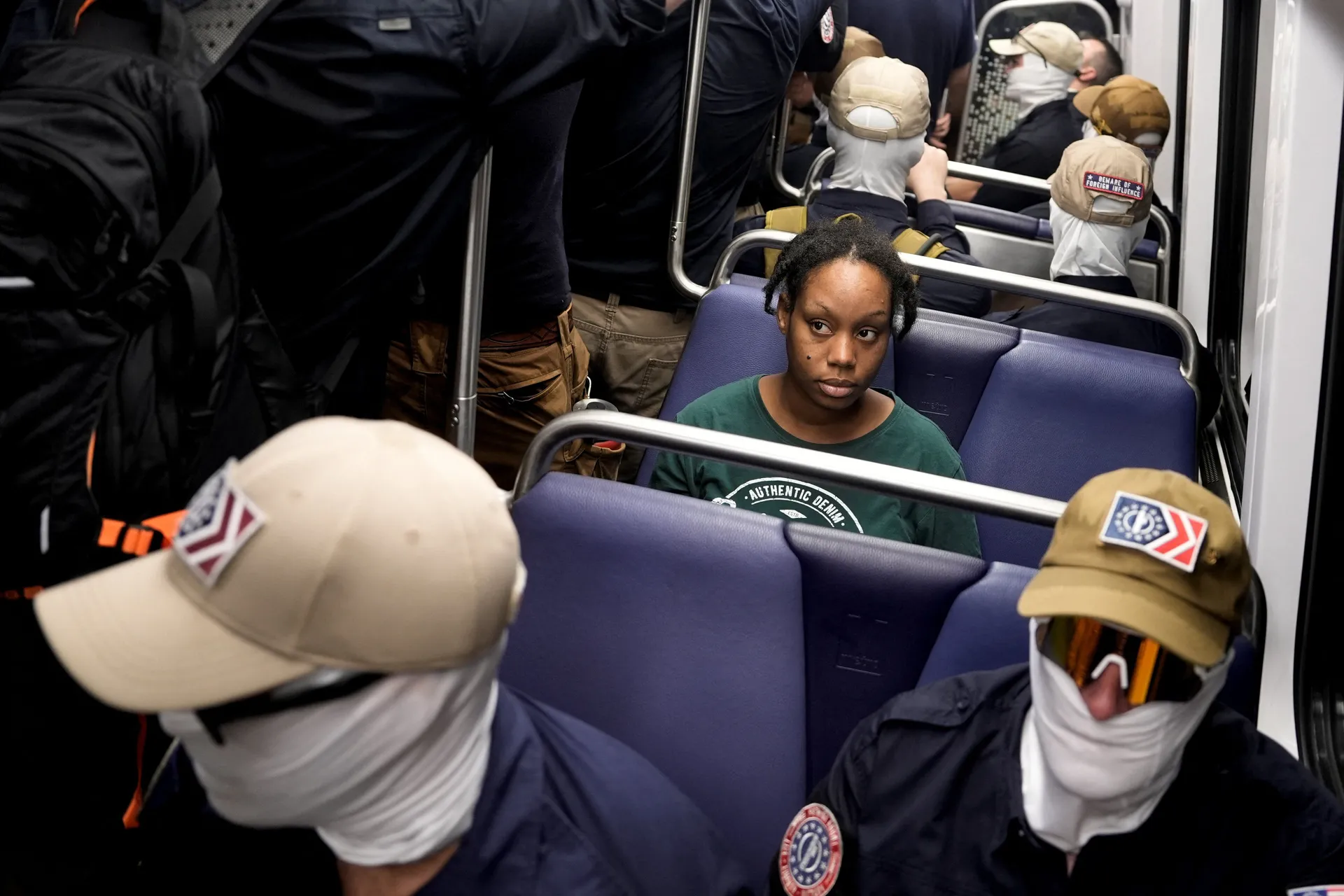 Members of the group Patriot Front ride the metro as a commuter looks on, during the 250th anniversary of U.S. independence in Washington, D.C., U.S., July 4, 2026. REUTERS/Cheney Orr