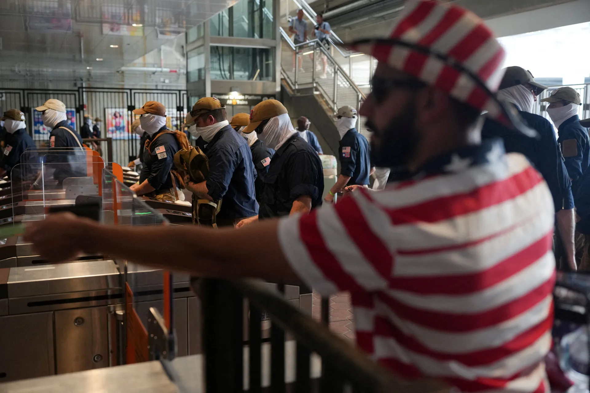 Members of the group Patriot Front walk among commuters at a metro station, on the 250th anniversary of U.S. independence in New Carrollton, Maryland, U.S, July 4, 2026. REUTERS/Nathan Howard    REFILE - CORRECTING LOCATION FROM "WASHINGTON, D.C" TO "NEW 
