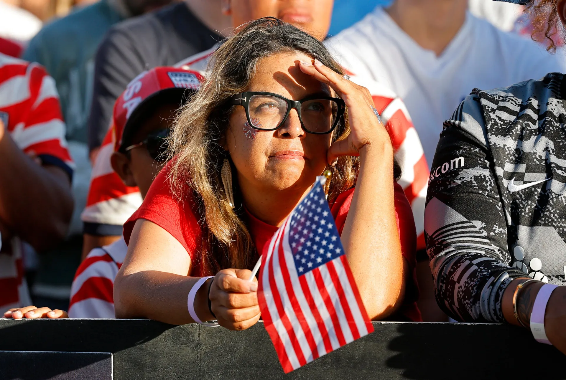 Soccer Football - FIFA World Cup 2026 - Round of 16 - United States v Belgium - Fans gather in San Diego, California, U.S. - July 6, 2026 U.S. fan holds a small national flag during a gathering to watch the match in San Diego REUTERS/Mike Blake