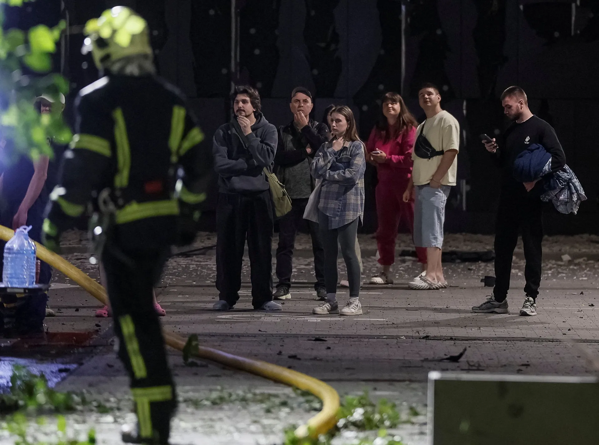 Residents stand at the site of an apartment building damaged during Russian missile strikes, amid Russia’s attack on Ukraine, in Kyiv, Ukraine July 19, 2026. REUTERS/Gleb Garanich