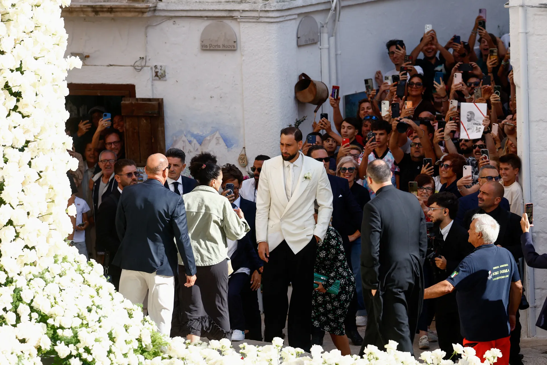Manchester City goalkeeper Gianluigi Donnarumma arrives for his wedding to Alessia Elefante at the Church of San Giorgio Martire as members of the public look on in Locorotondo, Italy, July 24, 2026. REUTERS/Alessandro Garofalo