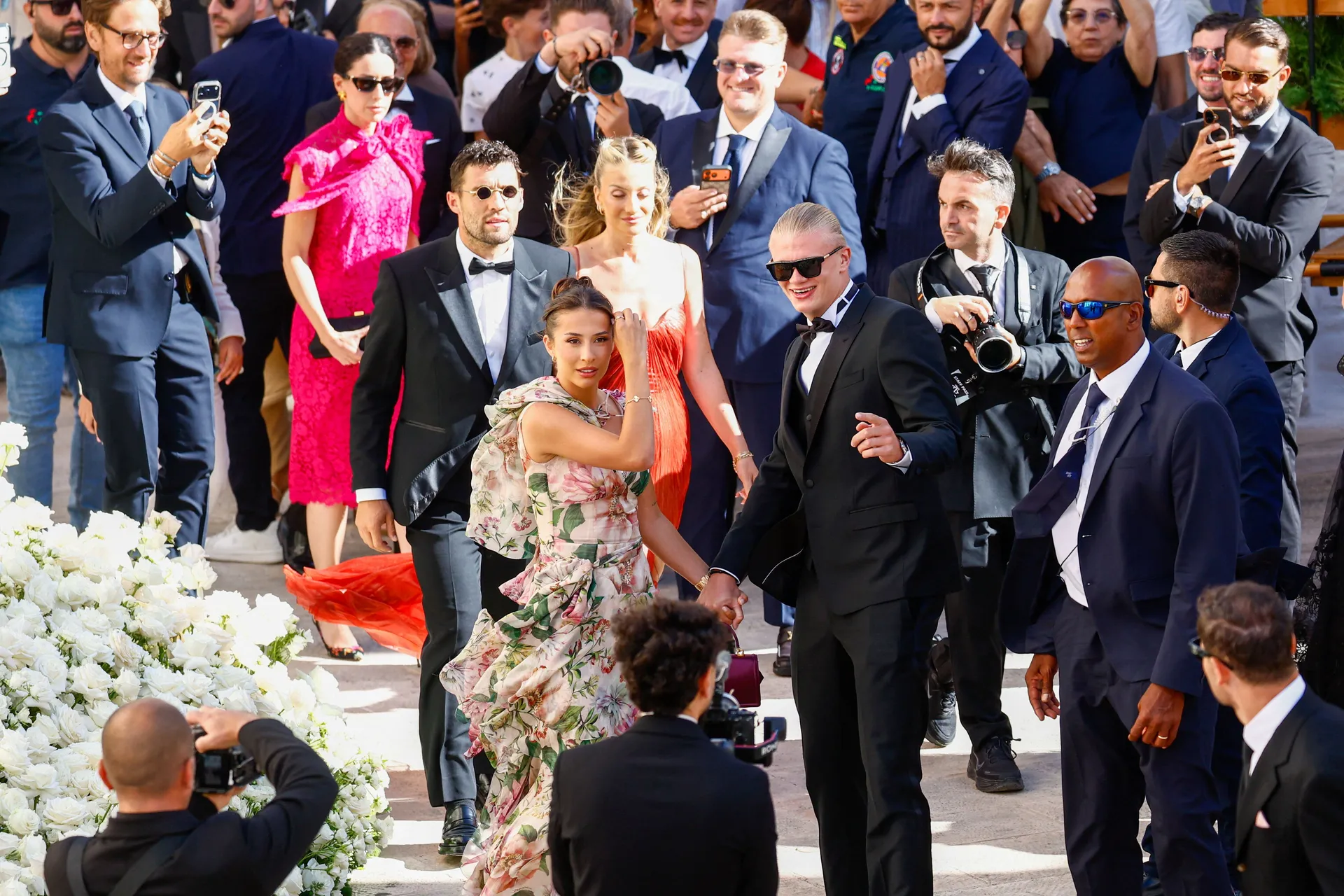 Manchester City forward Erling Haaland and his partner Isabel Haugseng Johansen arrive for the wedding ceremony of his teammate, Manchester City goalkeeper and Italy captain Gianluigi Donnarumma and Alessia Elefante at the Chiesa Madre di San Giorgio Mart