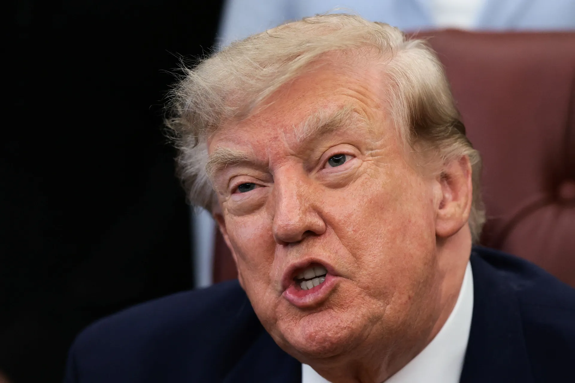 U.S. President Donald Trump answers questions from the media after signing an executive order establishing the President's Military Spouse Commission to be chaired by Jennifer Rauchet, wife of Secretary of Defense Pete Hegseth, in the Oval Office at the W