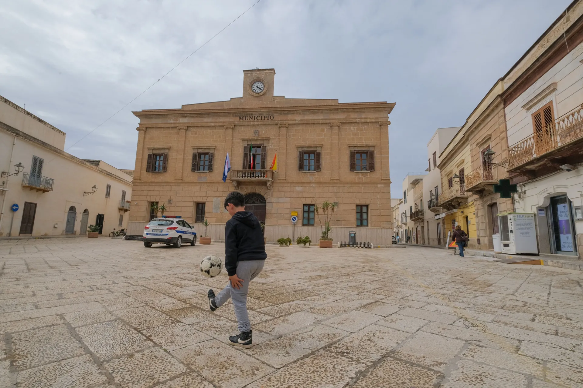 A boy plays football outside Favignana's municipal building in Favignana, Italy, May 5, 2021. Favignana was used as a filming location for Christopher Nolan’s "The Odyssey", released in Italy on July 16, 2026. REUTERS/Igor Petyx