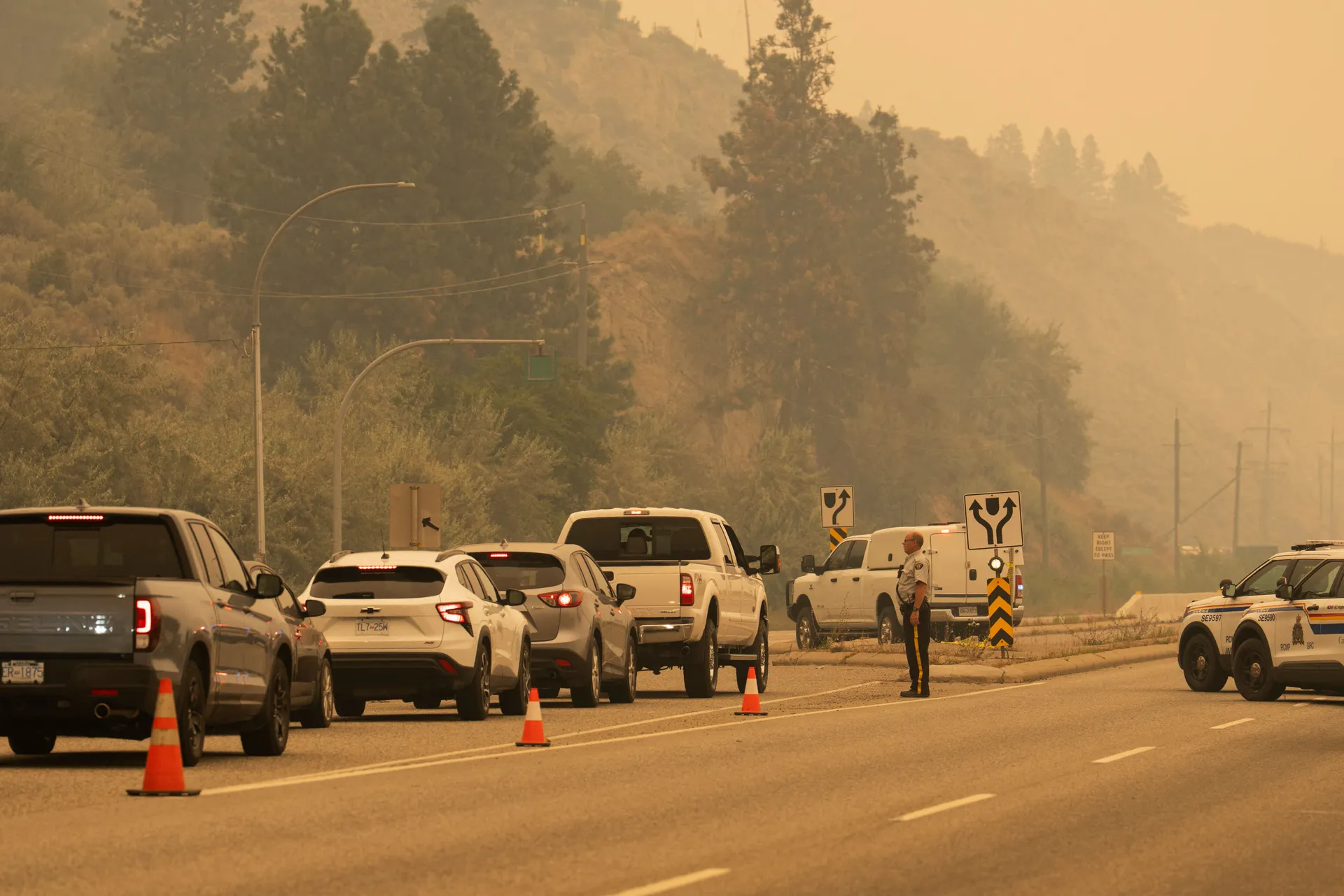 The Royal Canadian Mounted Police (RCMP) block Highway 97 Northbound to direct people away from the Bald Range wildfire in Penticton, British Columbia, Canada August 8, 2026. REUTERS/Paige Taylor White