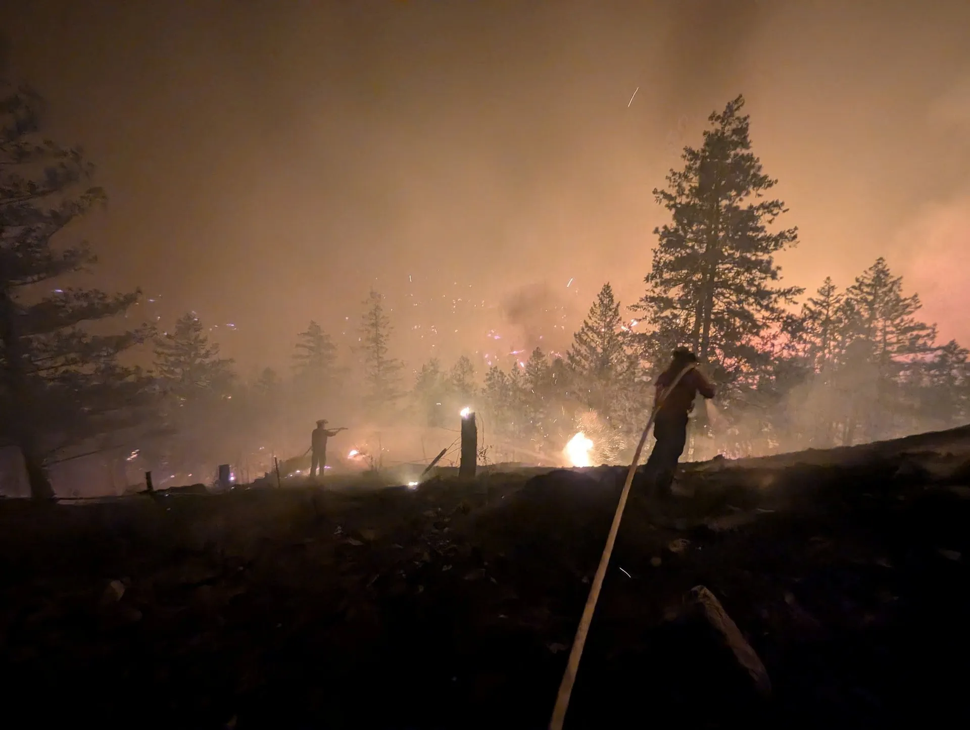 A crew suppresses the Bald Range wildfire northwest of Summerland, British Columbia, Canada August 7, 2026. Picture taken with a mobile phone. BC Wildfire/Handout via REUTERS. THIS IMAGE HAS BEEN SUPPLIED BY A THIRD PARTY