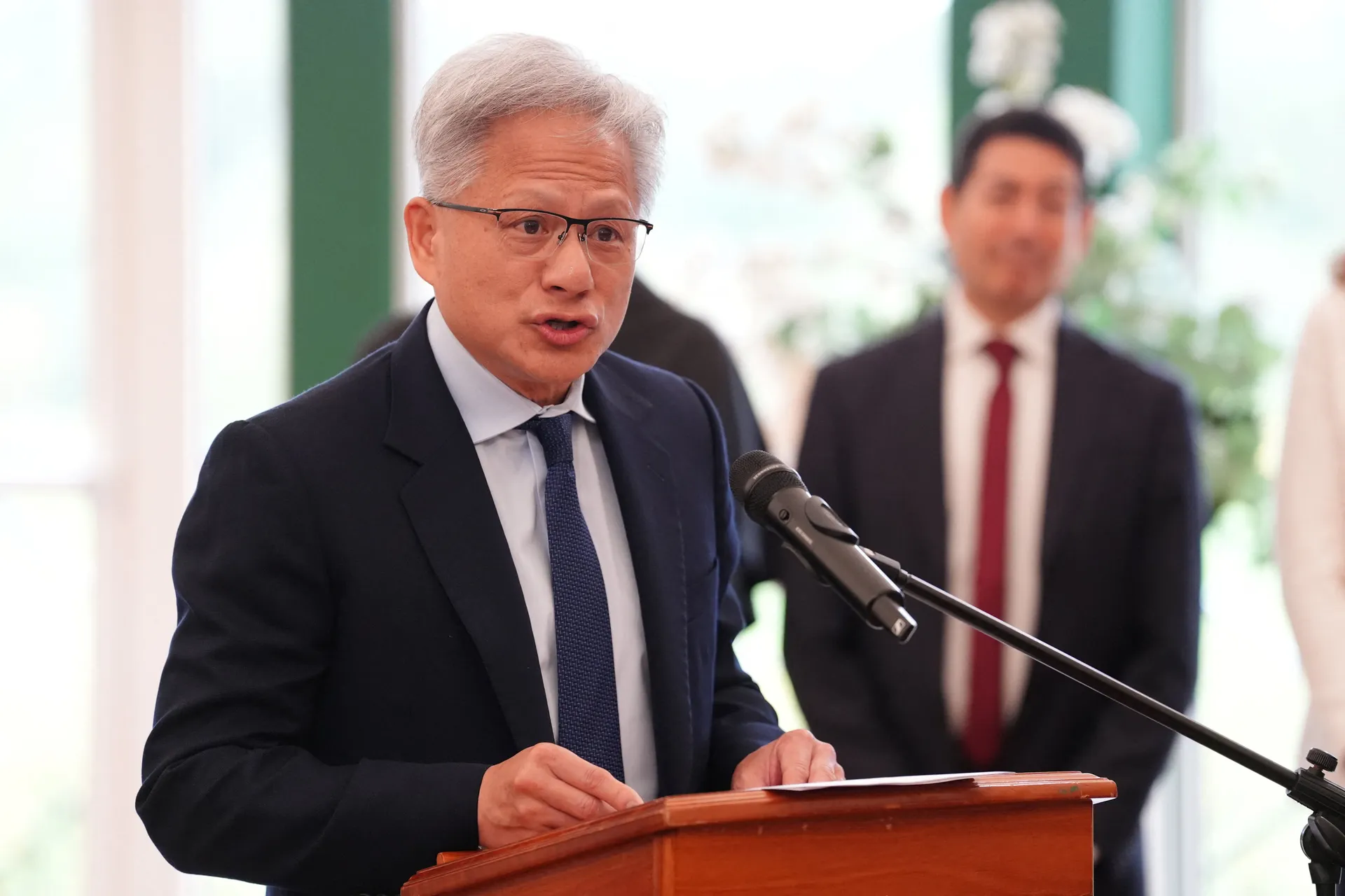 Nvidia CEO Huang gives a speech during a meeting for leaders from the artificial intelligence (AI) sector, Government, and thought leaders to discuss how AI can be developed and deployed in ways that benefit society, at Dumfries House in Cumnock, Britain,