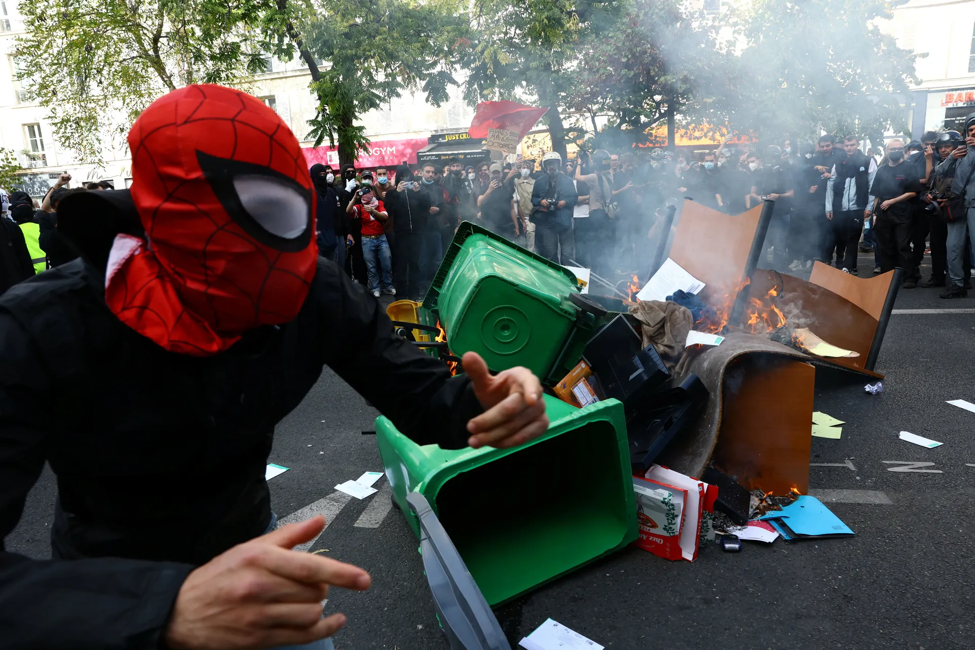 Garbage bins and other objects are set on fire by protesters amid clashes with French police during a demonstration by high school and university students, supported by teachers' union and school parents, in Paris as part of a nationwide day of demonstrat