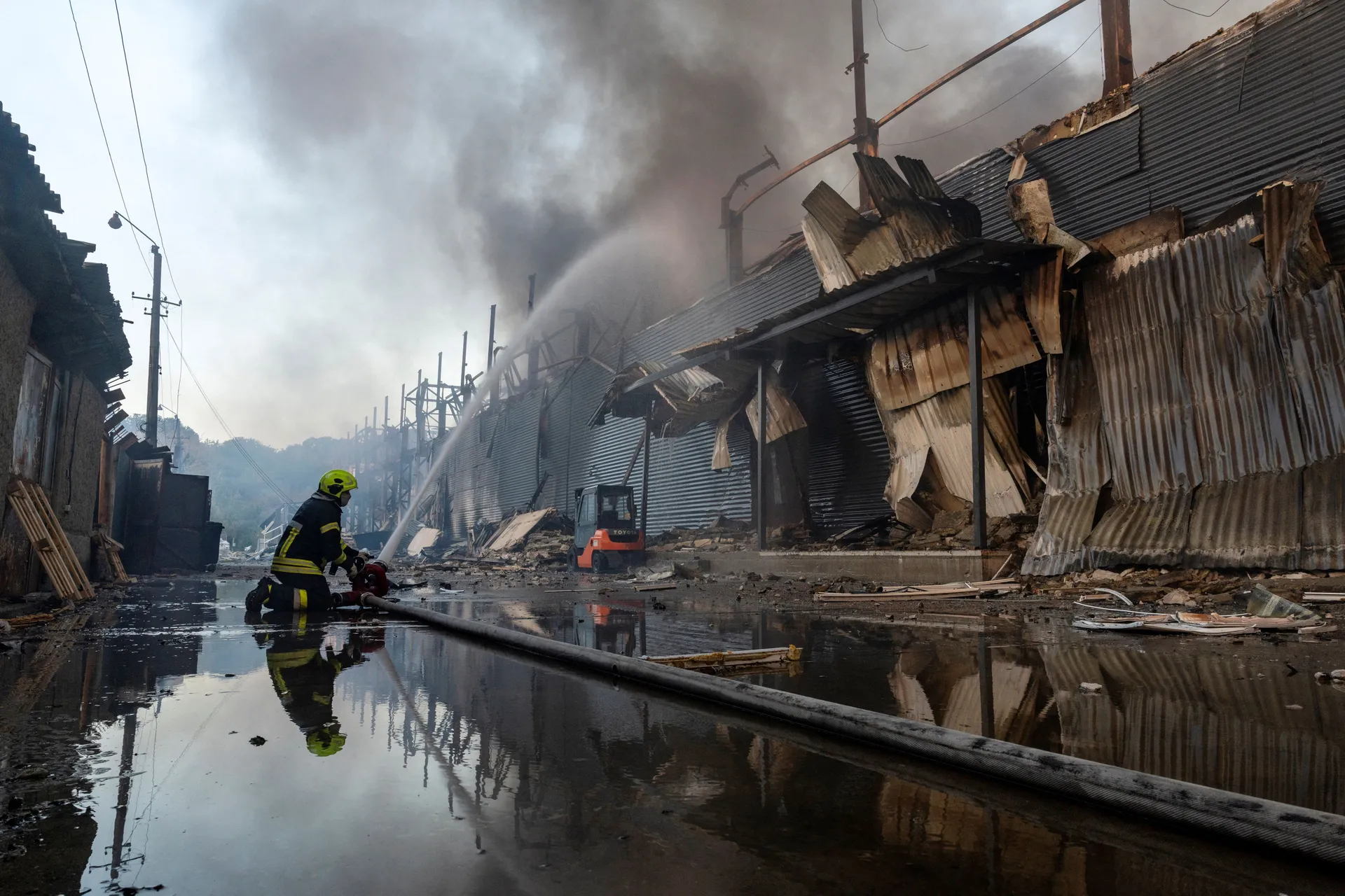 A firefighter works at the site of a warehouse that burned out after it was hit during a night of Russian missile attacks, amid Russia's attack on Ukraine, in Kyiv, Ukraine October 7, 2026. REUTERS/Thomas Peter