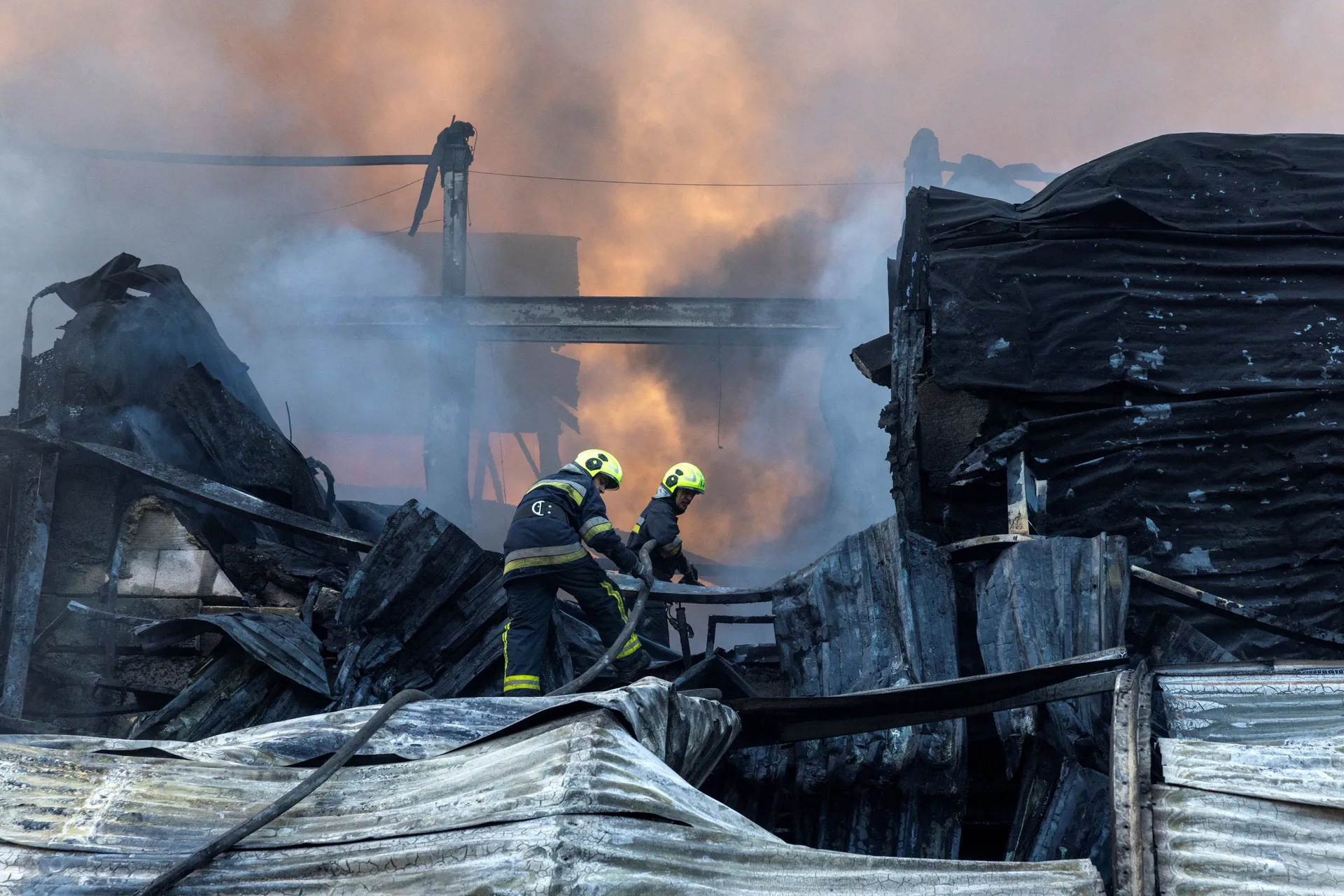Firefighters work at the site of a warehouse that burned out after it was hit during a night of Russian missile attacks, amid Russia's attack on Ukraine, in Kyiv, Ukraine October 7, 2026. REUTERS/Thomas Peter