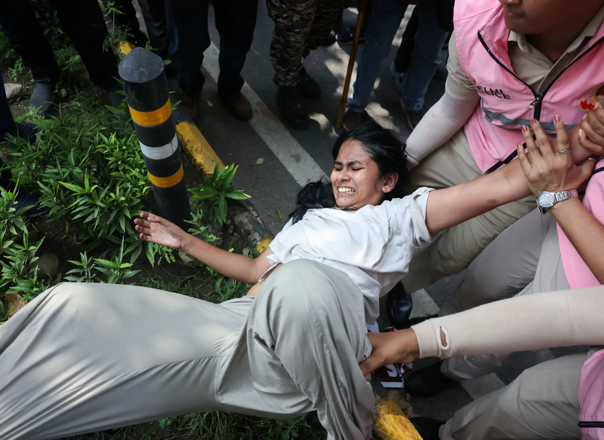 A protester is detained by security personnel during a protest by the Cockroach Janta Party (CJP) seeking the resignation of India's Chief Election Commissioner Gyanesh Kumar, near the protest site in New Delhi, India, October 10, 2026. REUTERS/Bhawika Ch