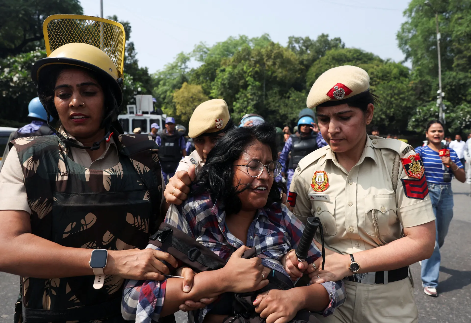 Security personnel detain a supporter of the Cockroach Janta Party (CJP) during a protest seeking the resignation of India's Chief Election Commissioner, Gyanesh Kumar, in New Delhi, India, October 10, 2026. REUTERS/Priyanshu Singh