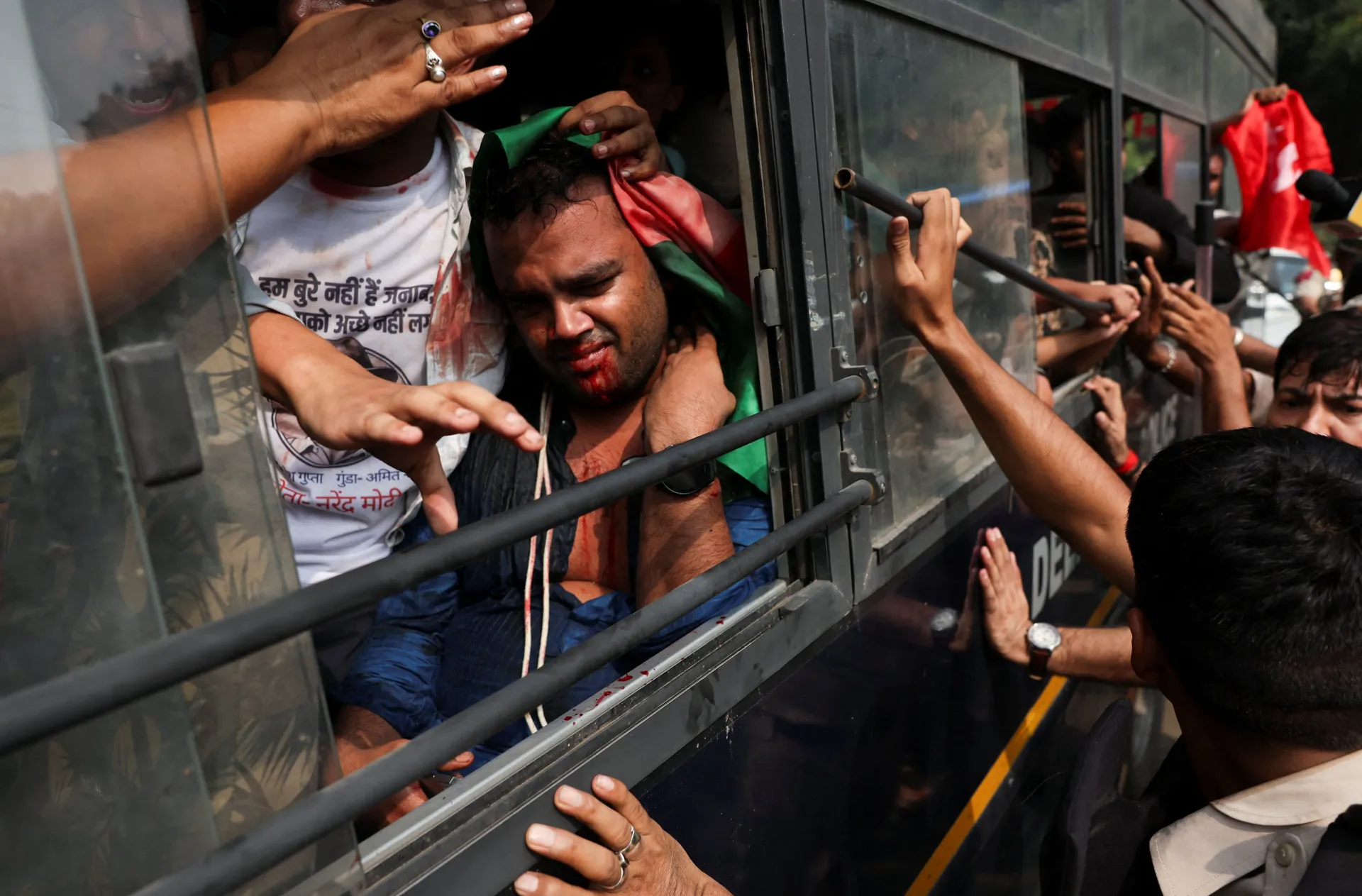 A protester bleeds as he sits inside a police bus after getting detained during a protest organised by the Cockroach Janta Party (CJP) seeking the resignation of India's Chief Election Commissioner, Gyanesh Kumar, in New Delhi, India, October 10, 2026. RE