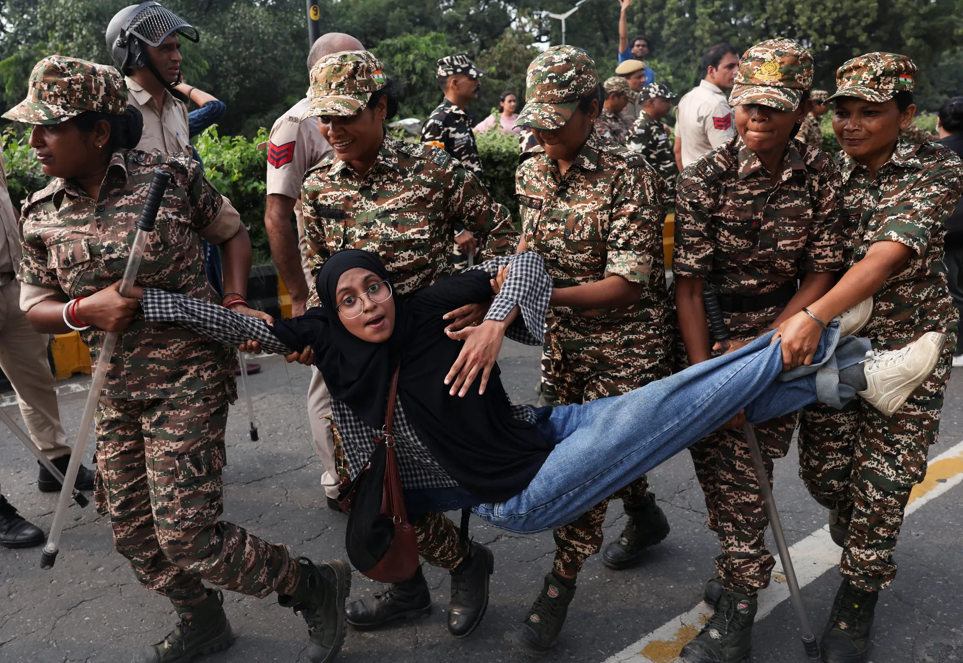 A protester is detained by security personnel during a protest by the Cockroach Janta Party (CJP) seeking the resignation of India's Chief Election Commissioner Gyanesh Kumar, near the protest site in New Delhi, India, October 10, 2026. REUTERS/Priyanshu 