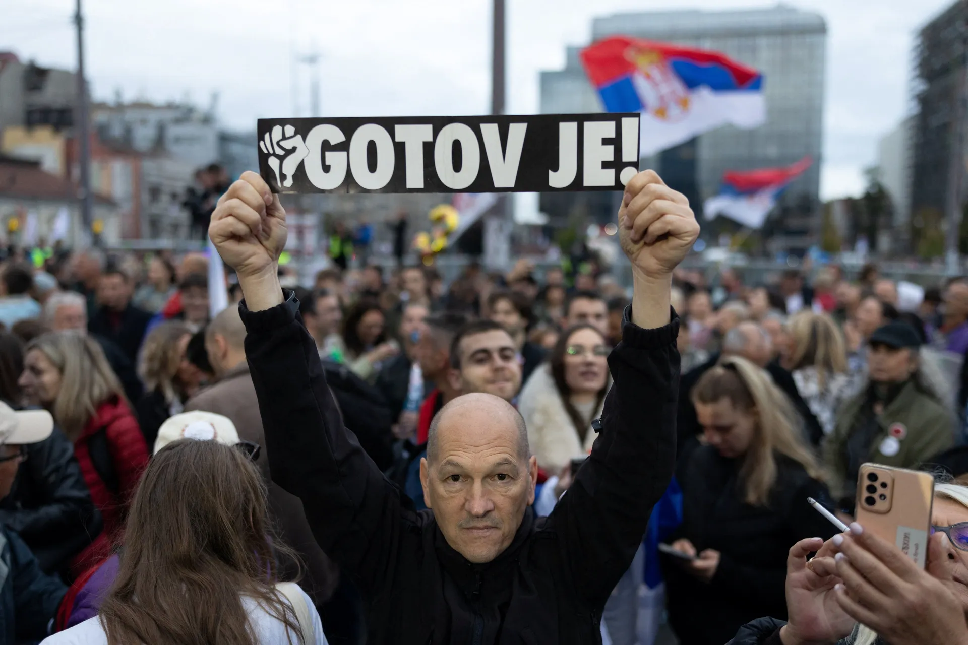 A supporter of the electoral list "Student List - Students Win" holds a sign reading "He is Finished!" referring to former Serbia’s President Aleksandar Vucic during a final campaign rally at Slavija Square in Belgrade, Serbia, October 22, 2026. REUTERS/U